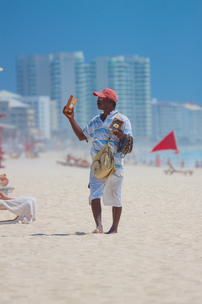 Vendor selling goods on beach in Cancun.