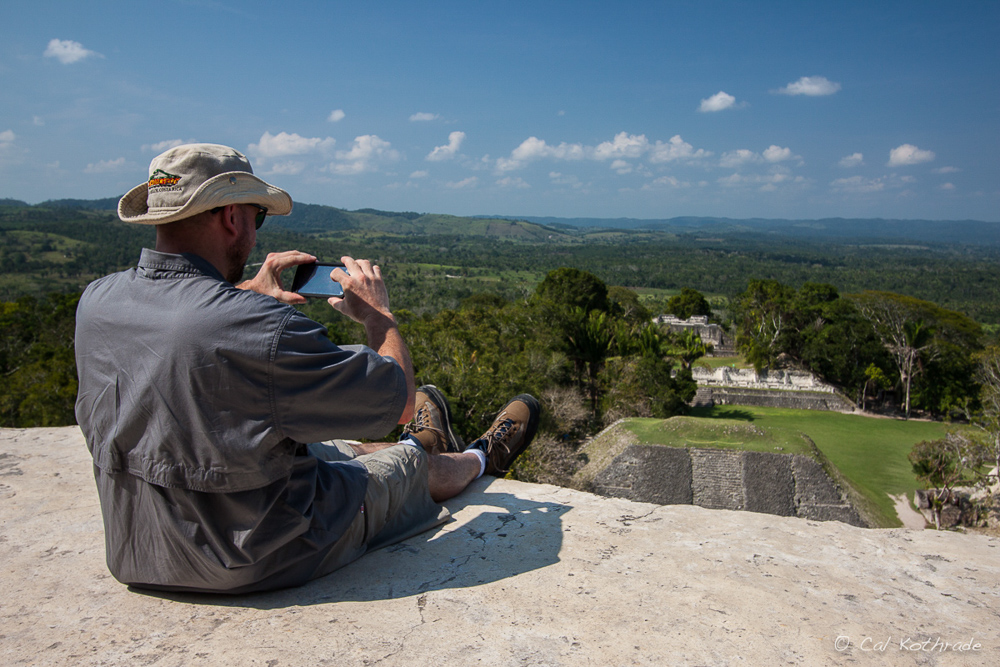 Man takes pictures of Mayan ruins from top of Xunantunich, Belize.